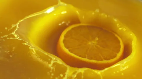 Orange circle falling into the orange juice Stock Footage 48432435