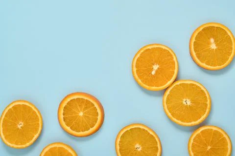 Orange citrus pattern composition. Orange slices with juice are scattered aro Stock Photos