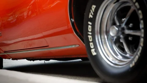 Orange classic car pulling away Stock Footage 119752285