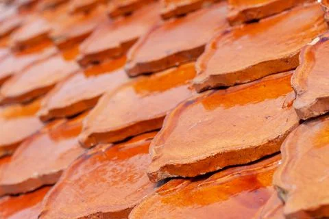 Orange clay tiles overlapping each other on the roof. Pattern from tile Stock Photos