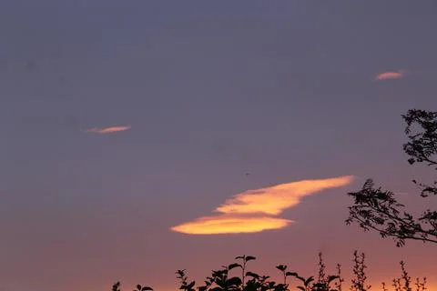 Orange cloud lit be the sun Stock Photos