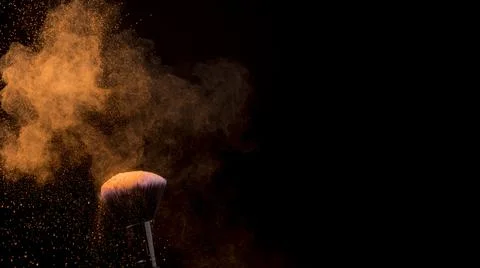 Orange cloud powder makeup brush dark background . High quality and resolution Stock Photos