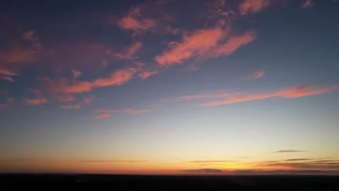 Orange clouds against a dark blue sky Stock Footage 302780679