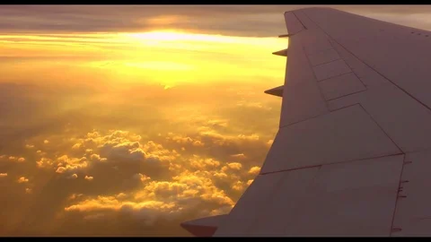 Orange clouds from an airplane window Stock Footage 119833031