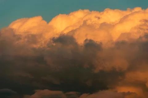 Orange clouds and sky background at golden hour time. Sunset Stock Photos
