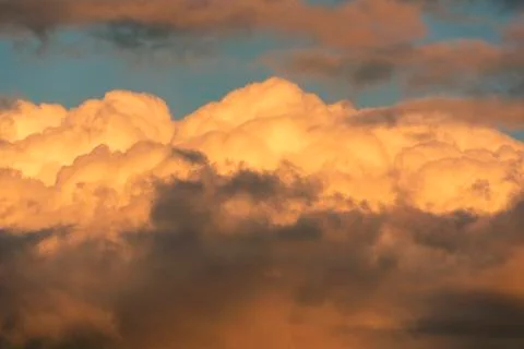 Orange clouds and sky background at golden hour time. Sunset Stock Photos