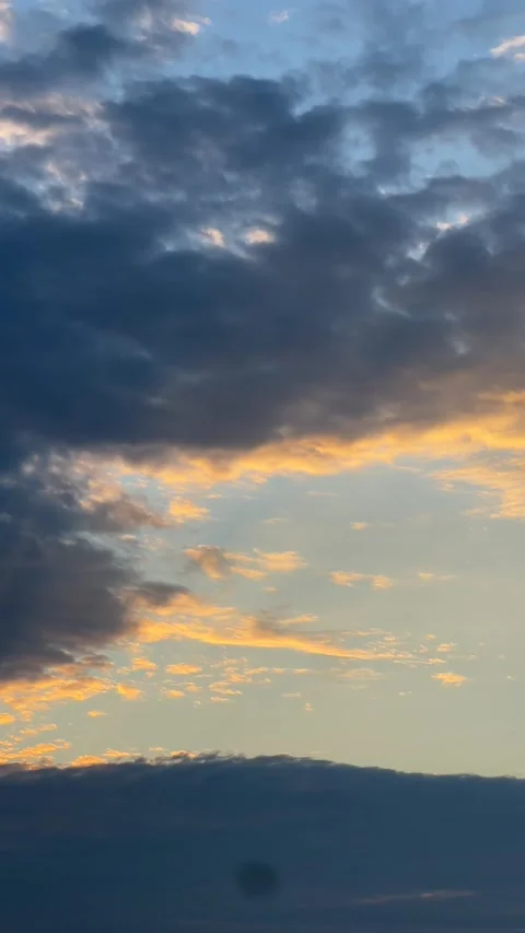 The orange clouds of the morning sky with the sun shining through them Stock Footage 196928059