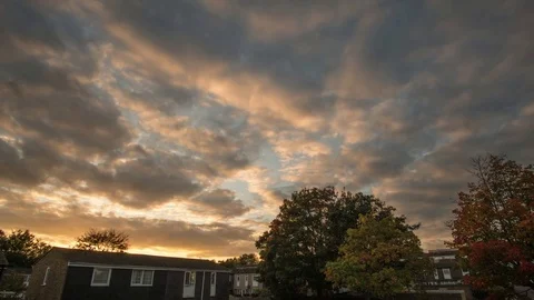 Orange clouds rolling in the sky during sunset,  Stock Footage 81142426