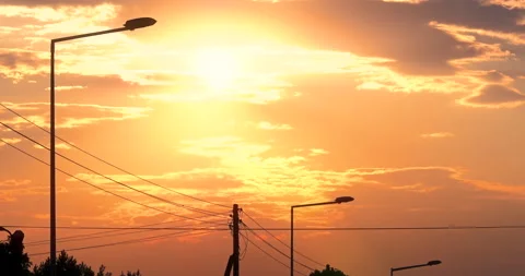 Orange Clouds Sunset in front of Lamp Posts Stock Footage 141142926