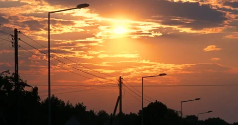 Orange Clouds Sunset in front of Lamp Posts Panning Stock Footage 141150458