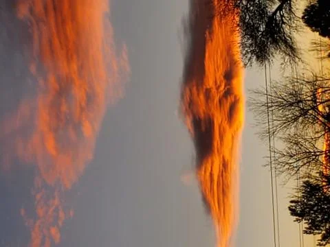 Orange clouds at sunset Stock Photos
