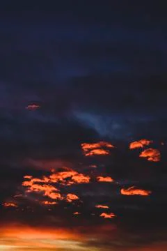 The orange clouds under dark sky Stock Photos