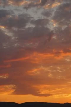 Orange cloudy sky during a sunset Stock-Fotos