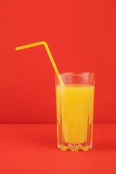 Orange cocktail drink on red background Stock Photos