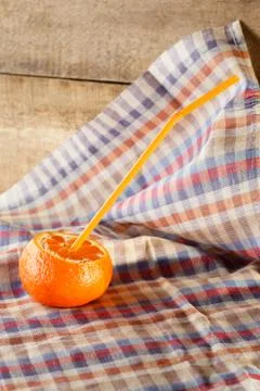 Orange with coctail straw Stock Photos