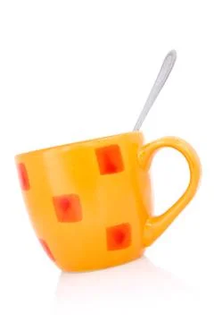 Orange coffee cup with a spoon Stock Photos