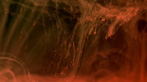 Orange color paint ink diffuses in water in slow motion on black background with Video stock 106349427