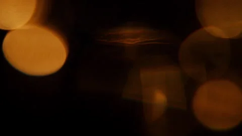 Orange-colored bokeh light leak reflections Video stock 293684749