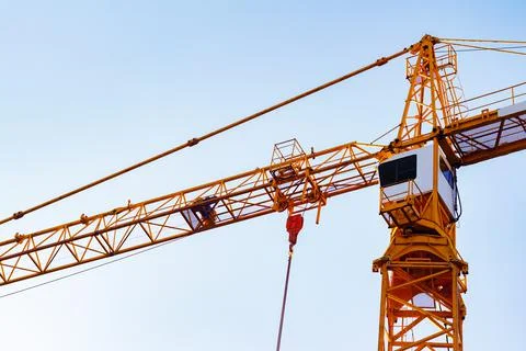 Orange colored building crane. Stock Photos