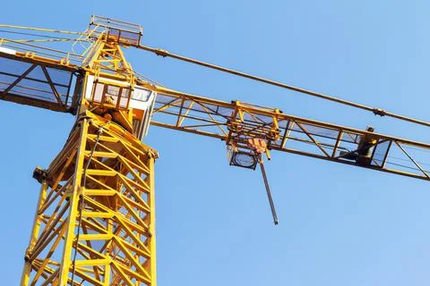 Orange colored building crane. Stock Photos