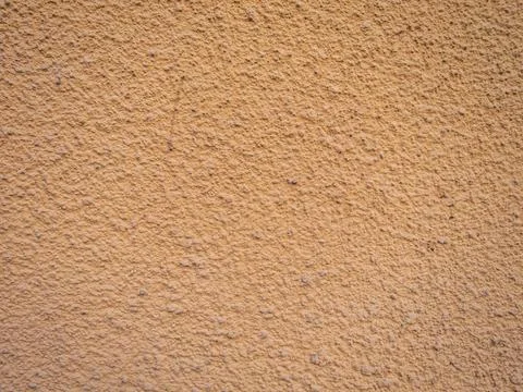 Orange-colored bumpy spotted rough wall texture Foto stock