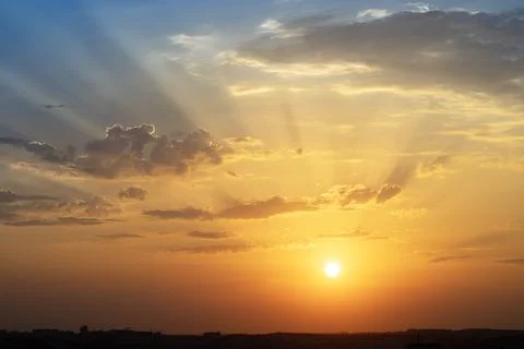 Orange colored dramatic sunset sky. Natural background Stock Photos