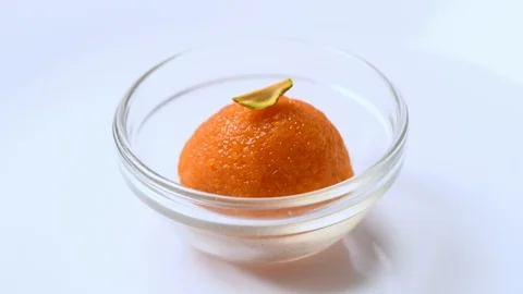 Orange colored indian sweets which are Motichur laddoos topped with piistachios Stock Footage 108332165