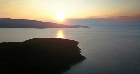 Orange colored sunset with reflection on the sea surface Stock Footage 108730843