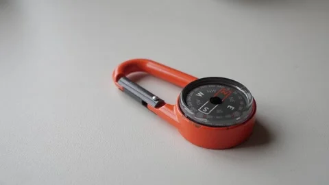 Orange Compass Carabiner for Precise Outdoor Navigation and Adventure Stock Footage 334580050