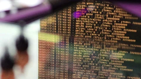 Orange computer software code moving on a black monitor reflect on glass. Abs 스톡 동영상 144047896
