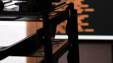 Orange computer software code moving on a black monitor reflect on glass. Abs Stock Footage 144049753