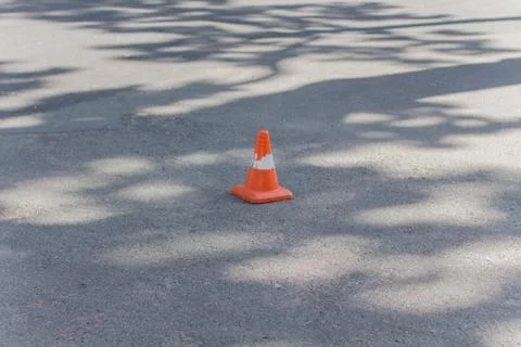 Orange cone on the pavement Stock Photos
