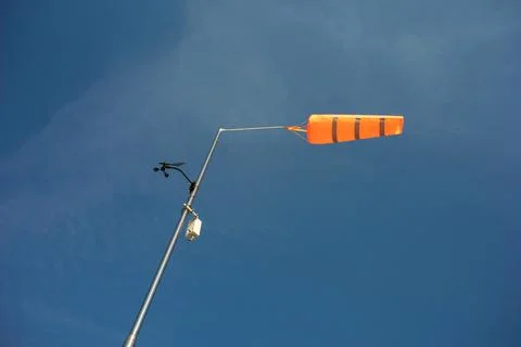 Orange conical windsock and wind cone - meteorologic device and tool on pole Stock Photos