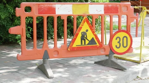 Orange construction barrier with warning sign and speed limit indicator Stock Footage 340275073