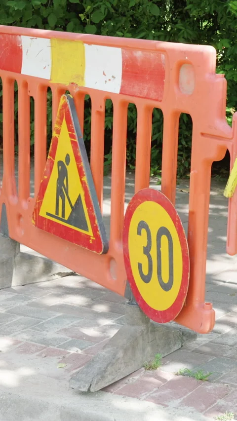 Orange construction barrier with warning sign and speed limit indicator Stock Footage 341438115