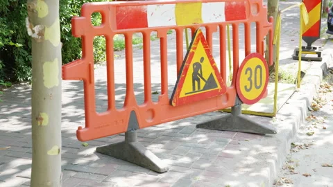 Orange construction barrier with warning signs and speed limit indicator Stock Footage 340554060