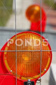 Orange construction site lamp at a construction site barrier, Germany, Europe Stock Photos