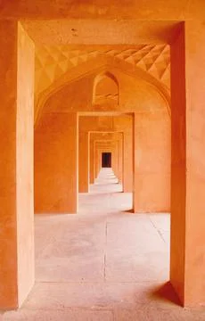 Orange corridor central view of consecutive doors Stock Photos