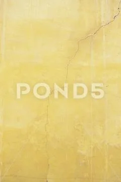 Orange cracked wall, detail of a textured, deterioration Stock Photos