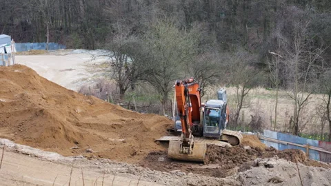 Orange crawler excavator digging earth at construction site. Video stock 332134064