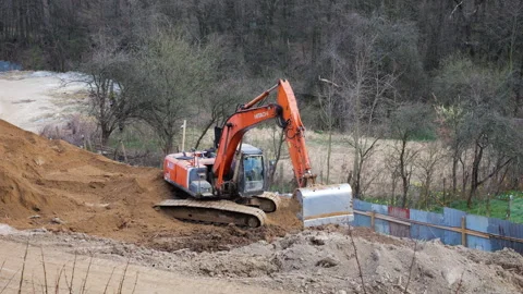 Orange crawler excavator digging earth at construction site. Stock Footage 332134683