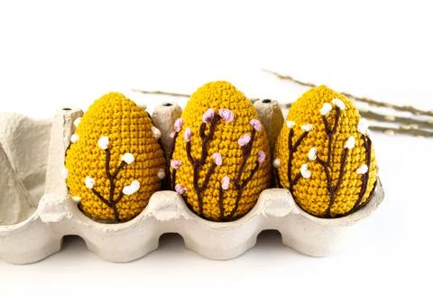 Orange crocheted Easter eggs in paper lattice on a white background. Easter E Stock Photos