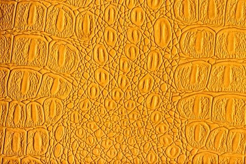 Orange crocodile leather texture. Abstract backdrop for design. Stock Photos