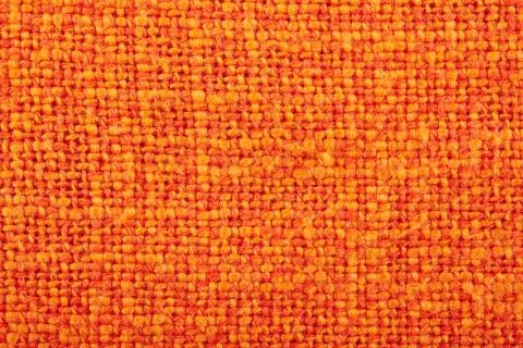 Orange crumpled burlap texture background. Macro of hessian cloth Stock Photos