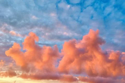 Orange cumulus clouds during sunset Stock Photos