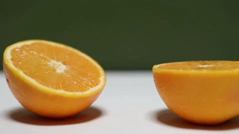 Orange cut in half. Cutting Of Orange Stock Footage 224117378