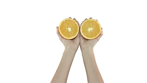 Orange cut in half, female hands on white background. Stock-Footage 71628587