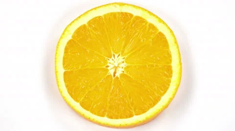 Orange cut in half top view isolated on white background, near the rotation. Stock Footage 63531899