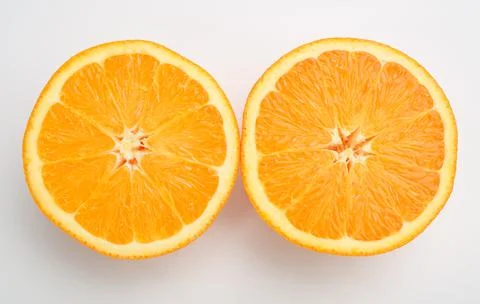 Orange cut in half on white background Stock Photos