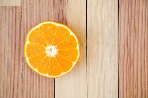 The orange cut in half on a wooden table Stock Photos